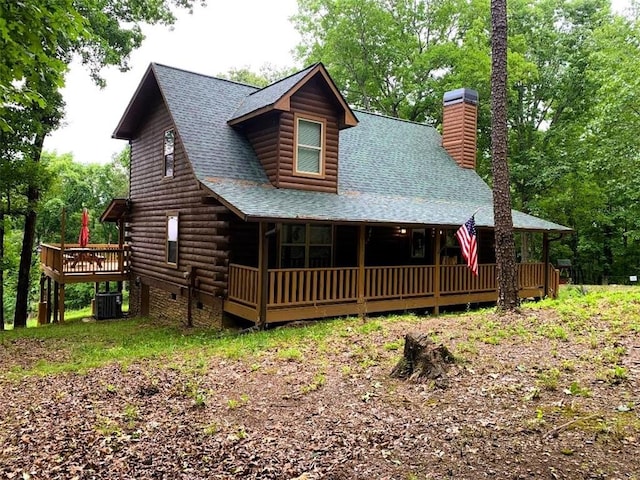 log cabin featuring central AC unit