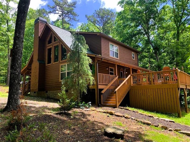 rear view of property with a wooden deck