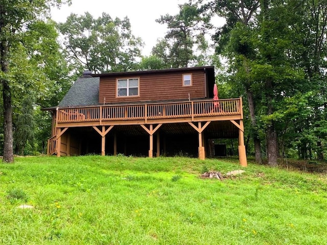 back of property featuring a yard and a deck