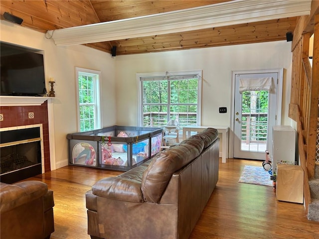 279 Gartrell St, Ellijay, GA 30540 - living room featuring wood finished floors, a wooden ceiling with exposed beams, and a tile fireplace