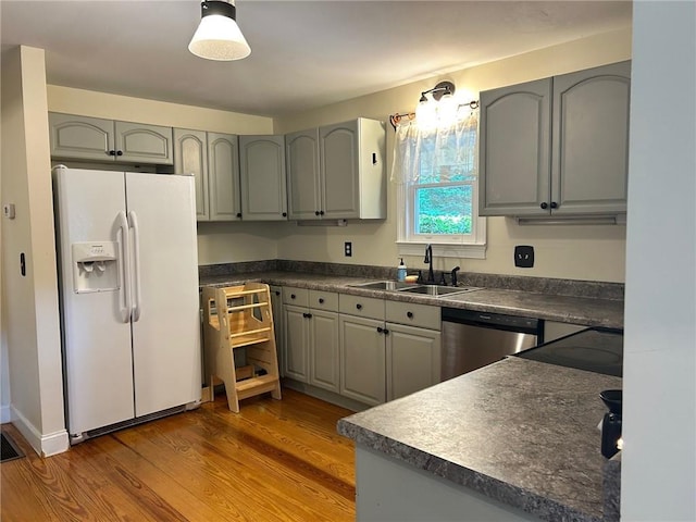 279 Gartrell St, Ellijay, GA 30540 - kitchen with white refrigerator with ice dispenser, dishwasher, dark countertops, gray cabinets, and wood finished floors