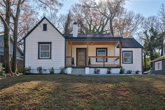 view of front of house with a front yard and a porch