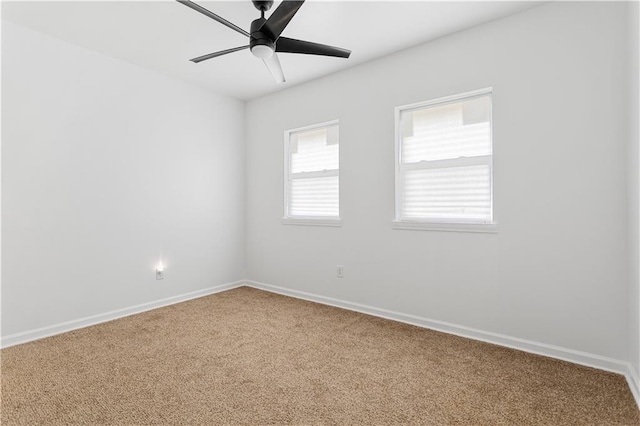 spare room with baseboards, carpet flooring, and ceiling fan