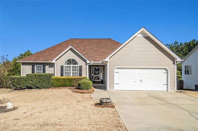 ranch-style home with concrete driveway and an attached garage