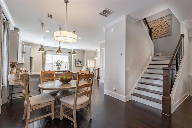 dining room featuring visible vents, dark wood-style floors, crown molding, and stairway