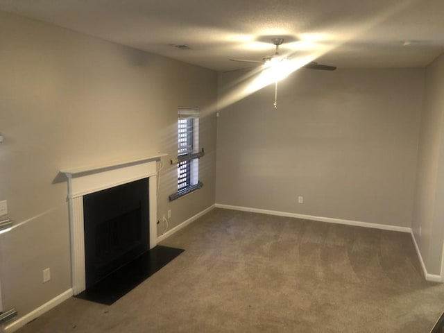 unfurnished living room with ceiling fan and carpet floors