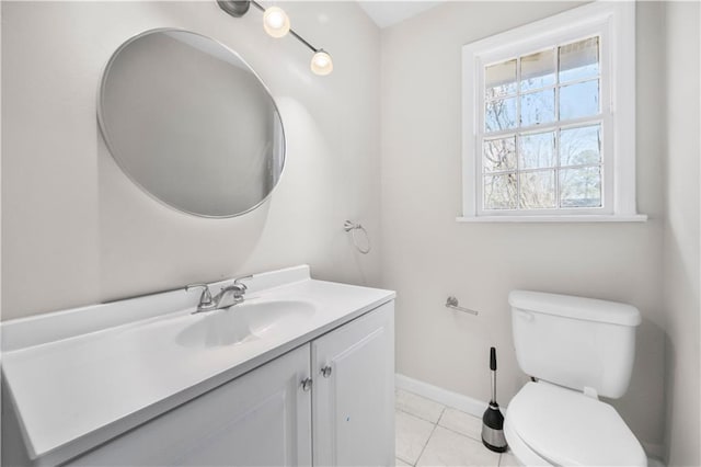 bathroom featuring tile patterned flooring, baseboards, vanity, and toilet