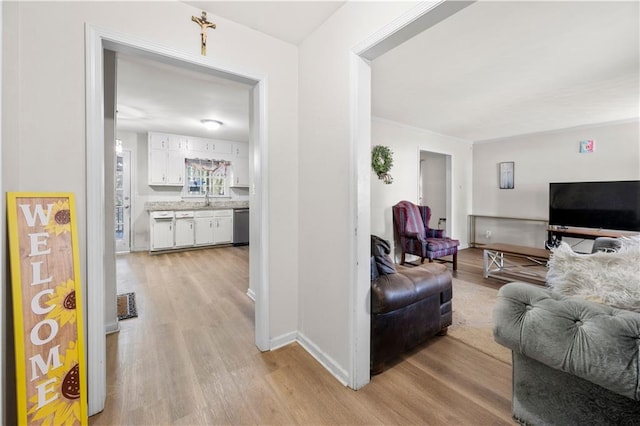 living room featuring light wood finished floors, visible vents, and baseboards