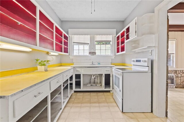5128 Lavista Rd, Tucker, GA 30084 - kitchen with electric stove, open shelves, and light floors