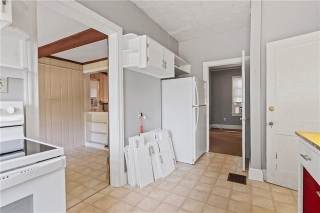 5128 Lavista Rd, Tucker, GA 30084 - kitchen with white appliances, light floors, white cabinetry, and open shelves
