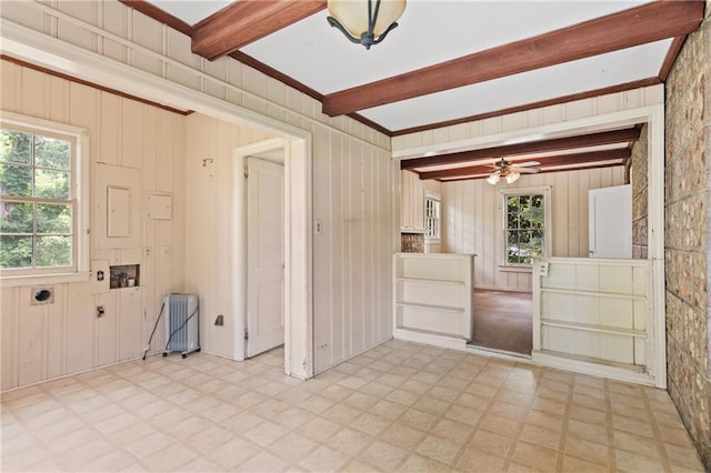 5128 Lavista Rd, Tucker, GA 30084 - unfurnished room with radiator heating unit, light floors, beamed ceiling, wooden walls, and a ceiling fan