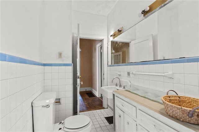 5128 Lavista Rd, Tucker, GA 30084 - bathroom featuring tile walls, toilet, tile patterned floors, and vanity