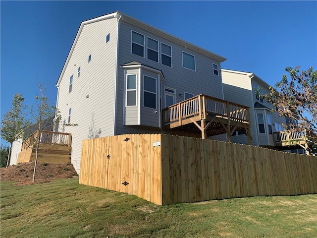 rear view of house featuring a yard