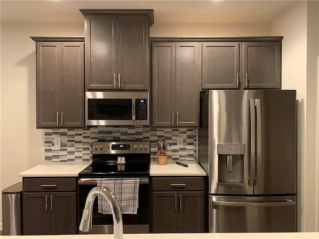 kitchen featuring tasteful backsplash, dark brown cabinetry, and appliances with stainless steel finishes