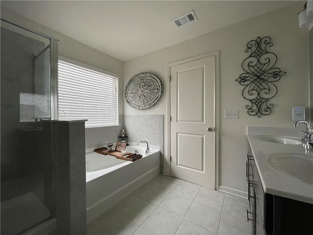 bathroom with vanity, shower with separate bathtub, and tile patterned floors