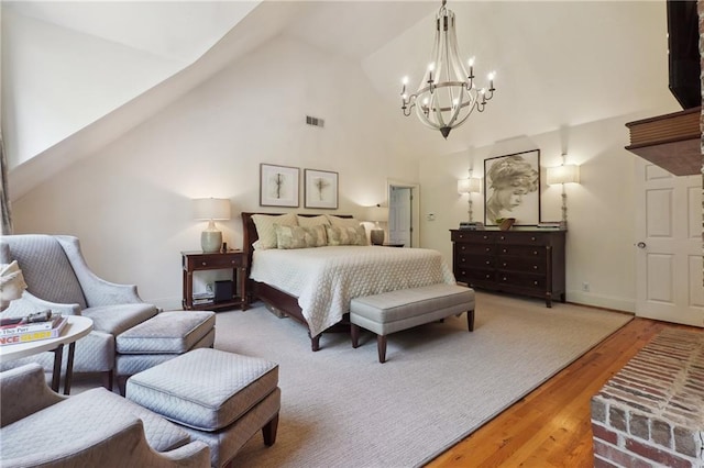 5122 Cantrell Pt SE, Acworth, GA 30101 - bedroom featuring high vaulted ceiling, a notable chandelier, wood finished floors, and visible vents