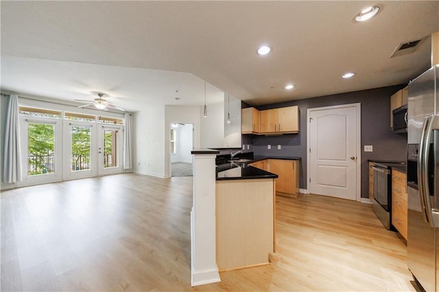390 17th St NW Unit 2053, Atlanta, GA 30363 - kitchen with stainless steel appliances, a peninsula, dark countertops, light wood-style flooring, and open floor plan