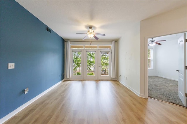 390 17th St NW Unit 2053, Atlanta, GA 30363 - unfurnished room featuring a ceiling fan, wood finished floors, and french doors