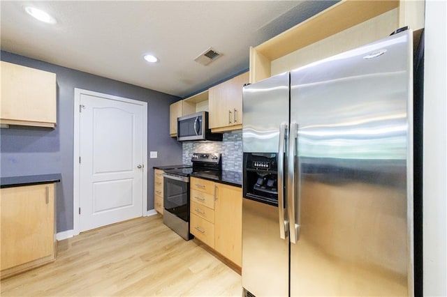390 17th St NW Unit 2053, Atlanta, GA 30363 - kitchen with stainless steel appliances, light brown cabinets, light wood-style flooring, dark countertops, and recessed lighting