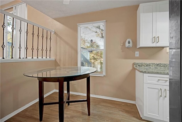 dining room featuring baseboards and light wood-style floors