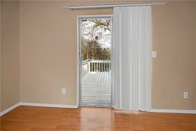 empty room featuring baseboards and wood finished floors