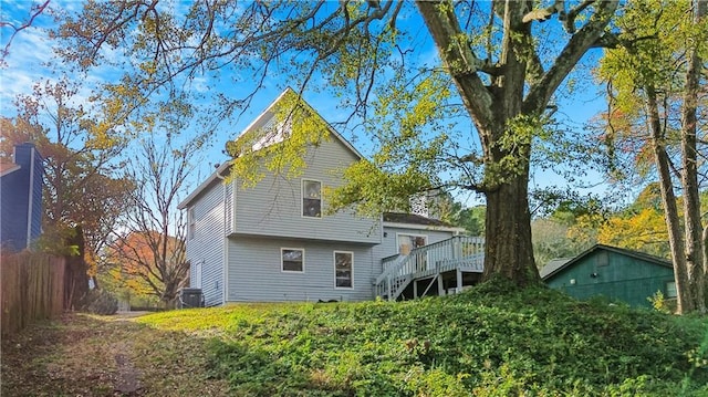 rear view of house with stairs, fence, cooling unit, and a wooden deck