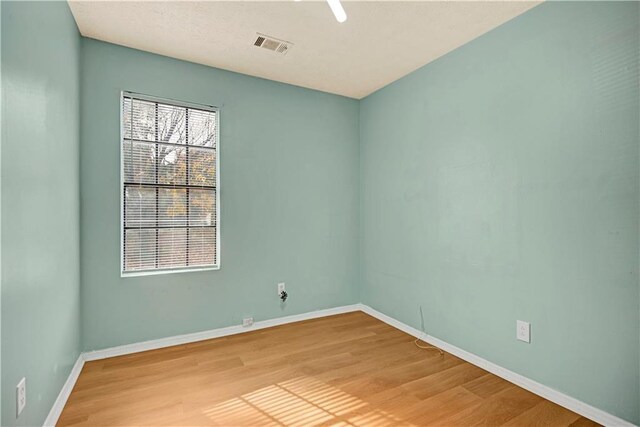 spare room with ceiling fan and light hardwood / wood-style floors