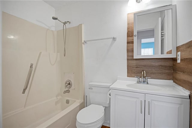 bathroom featuring toilet,  shower combination, and vanity