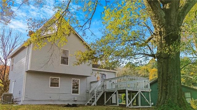 rear view of property featuring central AC and a deck