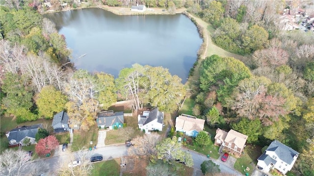 birds eye view of property with a forest view and a water view