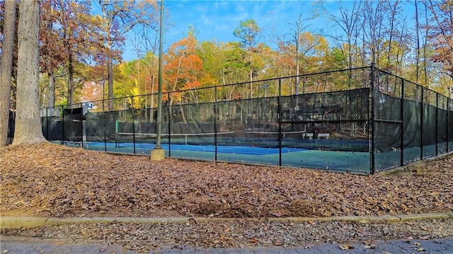 view of sport court featuring fence