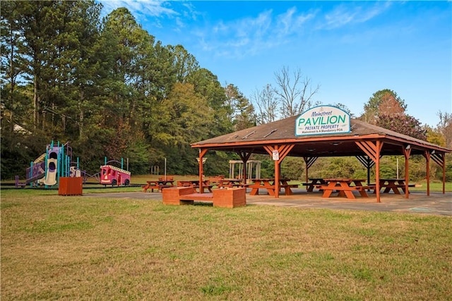 view of community with a gazebo, a playground, and a lawn