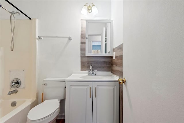 bathroom with toilet, vanity, and shower / bathing tub combination