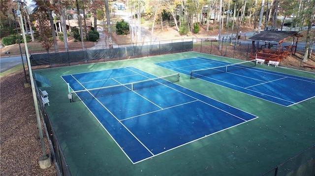 view of tennis court with fence