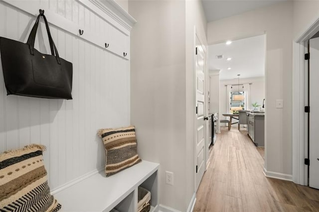 mudroom featuring light wood-style floors, baseboards, and recessed lighting