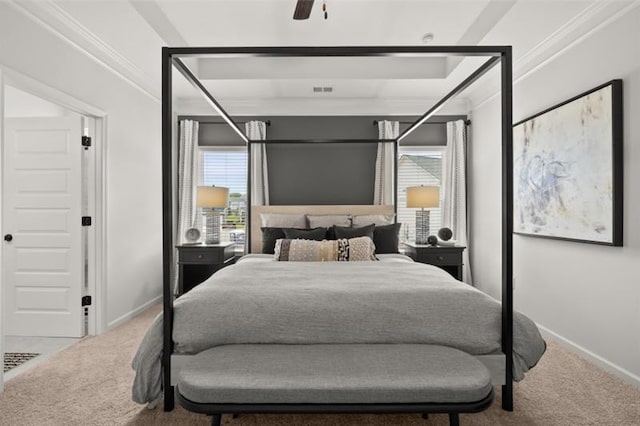 carpeted bedroom with visible vents, baseboards, a ceiling fan, and ornamental molding