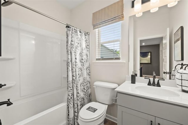 bathroom with shower / bath combo, vanity, toilet, and baseboards