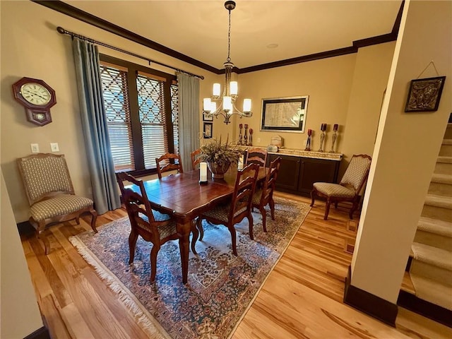 136 Timothy Park Ln, Athens, GA 30606 - dining area with a chandelier, ornamental molding, light wood-style floors, and stairway