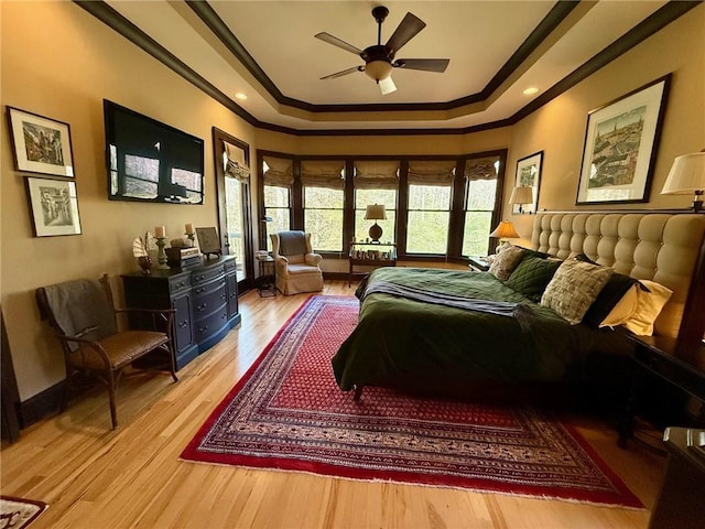 136 Timothy Park Ln, Athens, GA 30606 - bedroom with a tray ceiling, ornamental molding, light wood-type flooring, and baseboards