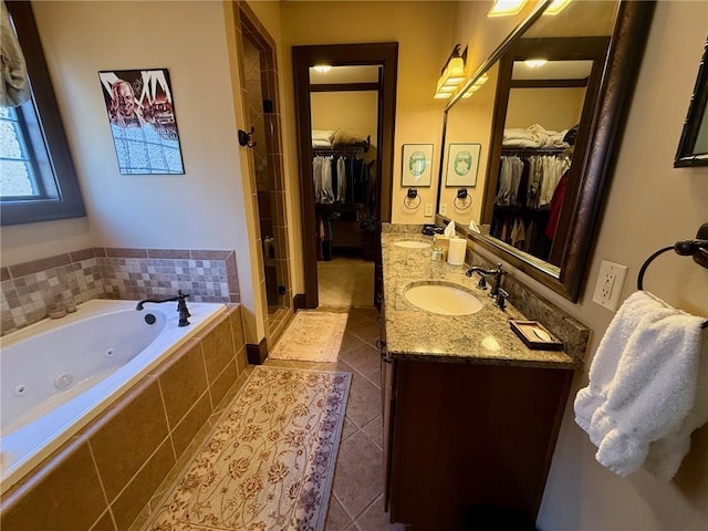 136 Timothy Park Ln, Athens, GA 30606 - bathroom featuring tile patterned flooring, a stall shower, double vanity, a tub with jets, and a spacious closet