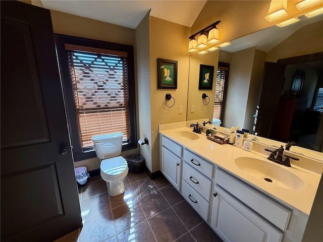 136 Timothy Park Ln, Athens, GA 30606 - full bath featuring toilet, double vanity, lofted ceiling, tile patterned floors, and baseboards