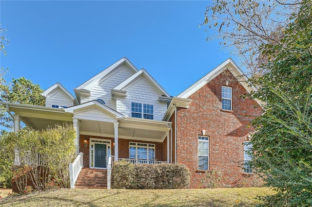 view of front of home with a front lawn and a porch