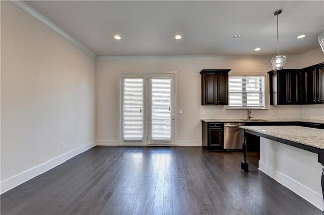 kitchen featuring a wealth of natural light, hanging light fixtures, and dark hardwood / wood-style flooring