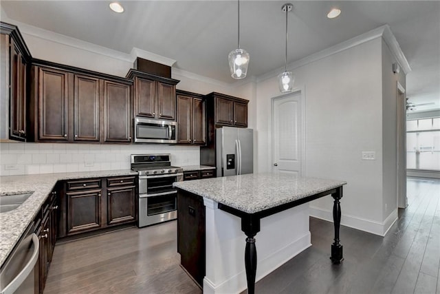 kitchen featuring stainless steel appliances, dark hardwood / wood-style flooring, light stone counters, and a kitchen breakfast bar