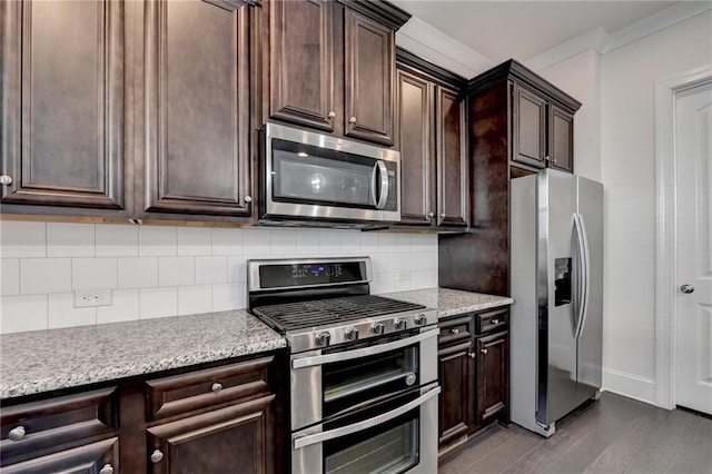 kitchen with light stone countertops, stainless steel appliances, tasteful backsplash, dark wood-type flooring, and dark brown cabinets