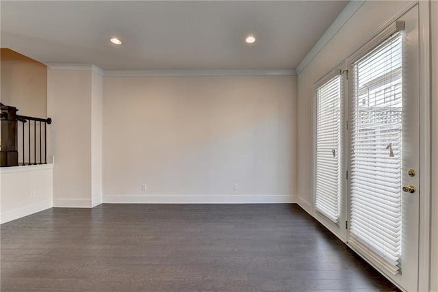 spare room featuring dark wood-type flooring and ornamental molding