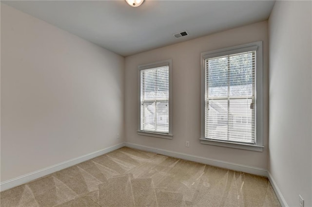 carpeted empty room with a healthy amount of sunlight