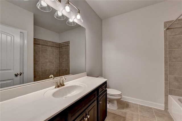 full bathroom featuring tiled shower / bath combo, tile patterned floors, vanity, and toilet