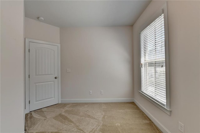 empty room featuring light carpet