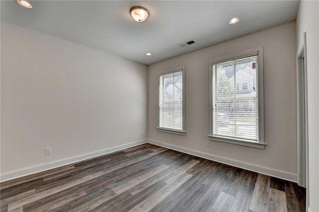 empty room featuring dark hardwood / wood-style flooring